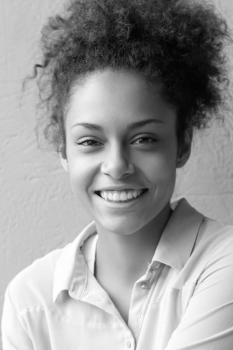 happy-mixed-race-woman-smiling-indoors-PTUBKYY-portret